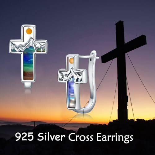 Silver cross earrings with mountain design and colorful inlay.