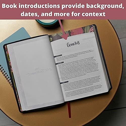 Open Bible with book introduction for Genesis on a table.