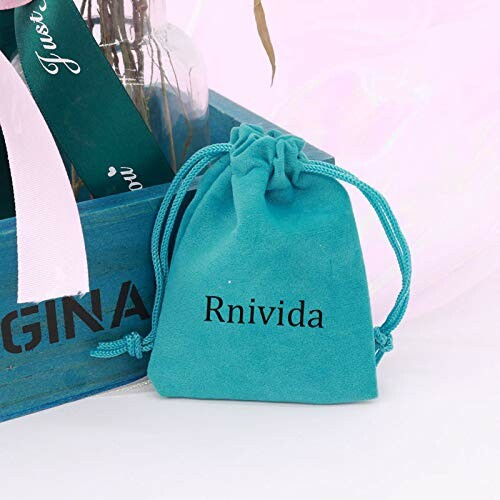 Blue drawstring bag labeled Rnivida next to a wooden box.