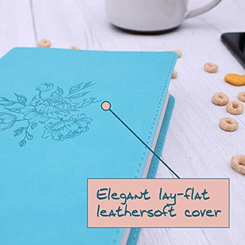 Blue notebook with lay-flat leathersoft cover on a table.