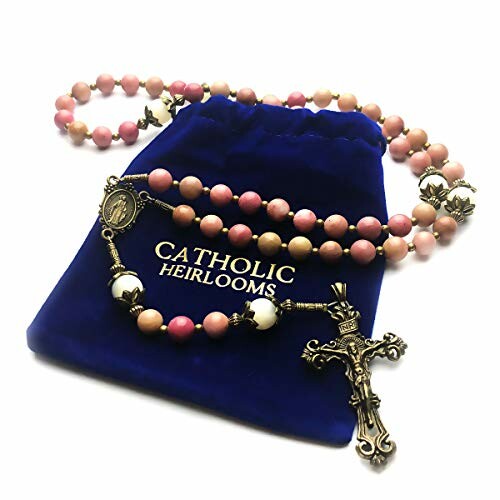 Rosary beads with crucifix on a blue Catholic Heirlooms pouch