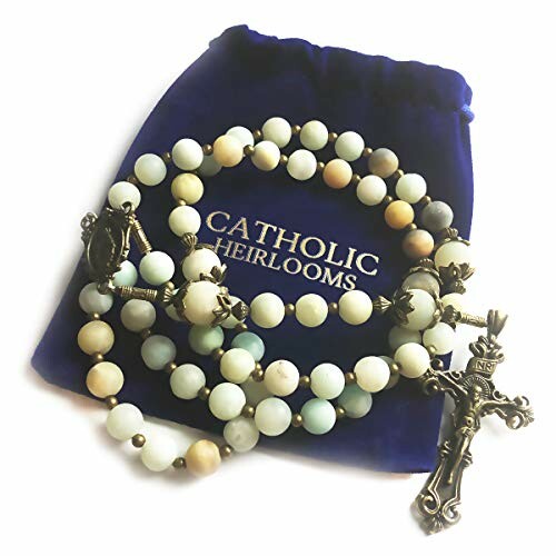 Catholic rosary beads with a crucifix on a velvet pouch