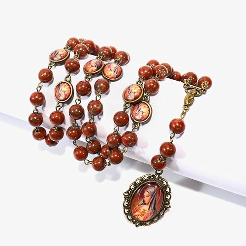 Red bead Catholic rosary with religious medallions