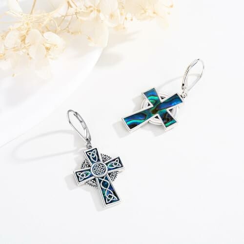 Celtic cross earrings with intricate design on white background