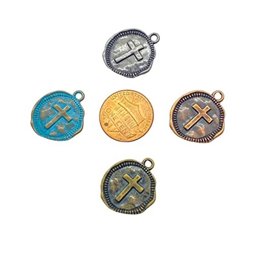 Set of four cross charms with varied finishes and a US penny for scale.