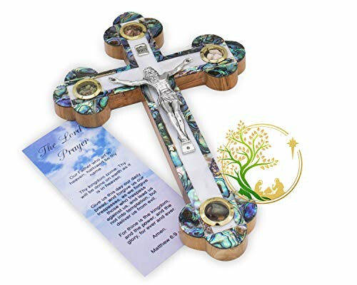 Decorative wall cross with religious symbols and a prayer card.