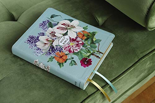 Bible with floral cover resting on a green sofa.