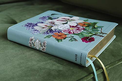 Bible with floral design on a green surface