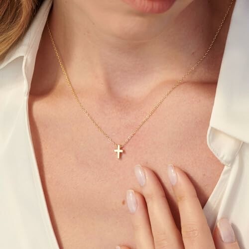 A close-up shot of the HANLI Cross Necklace, showcasing the intricate details of the cross pendant and the cubic zirconia stone.