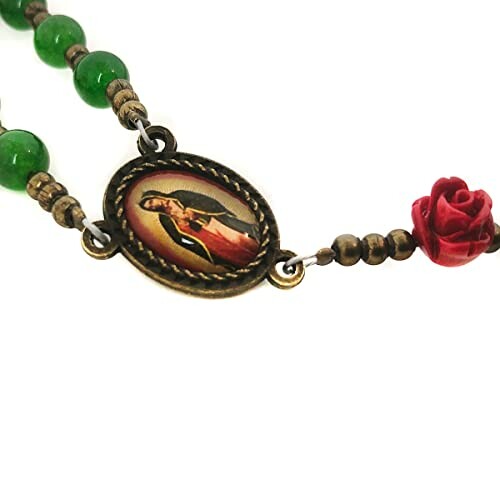 Green rosary necklace with religious medallion and red rose bead.