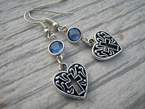 Heart-shaped earrings with cross design and blue stones.