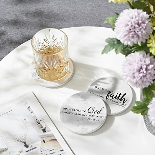 Glass of beverage on coaster with inspirational quotes on a table.