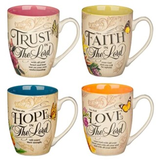 Set of four inspirational mugs with quotes and colorful designs.