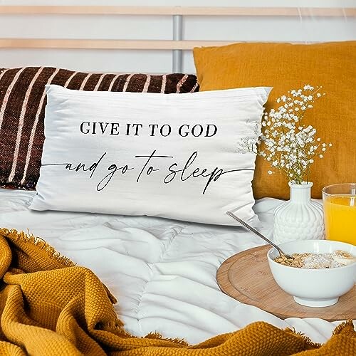 Decorative pillow with text on cozy bed setup