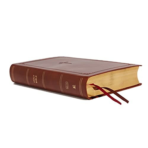 A leather-bound Bible with gold-edged pages and red bookmarks.