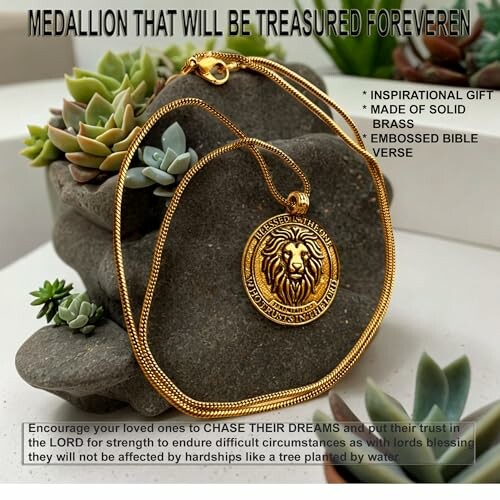 Golden lion medallion necklace displayed with succulents.