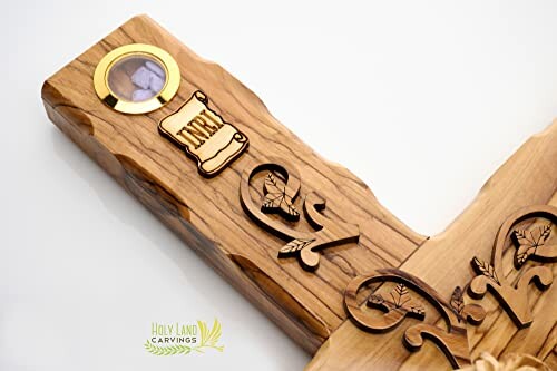 Olive wood carving with inkwell and decorative elements.