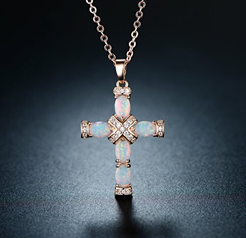 Opal cross pendant necklace on dark background
