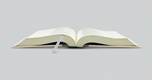 Open book with a bookmark on a table.