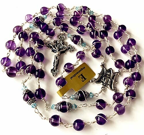 Purple rosary beads with a cross and religious symbols