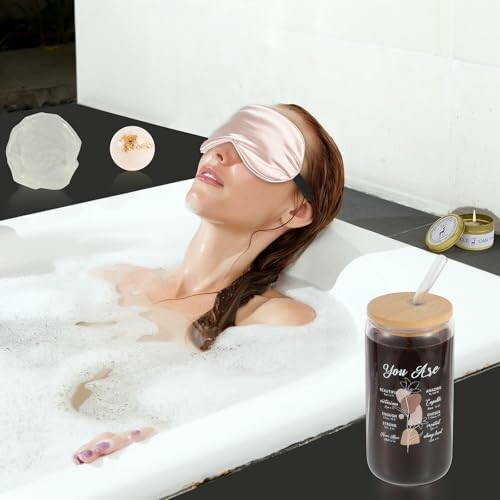 Rose bath ball, bluebell candle, and glass cup.