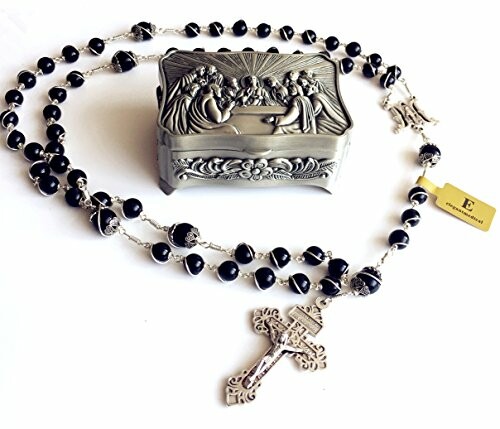 Black bead rosary with silver crucifix and ornate religious box.