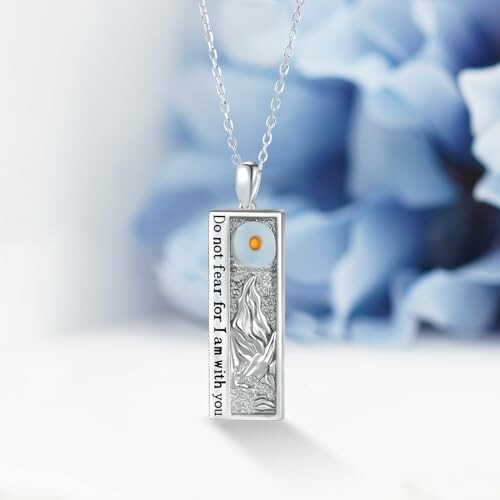 Silver rectangle pendant necklace with engraved design and text.