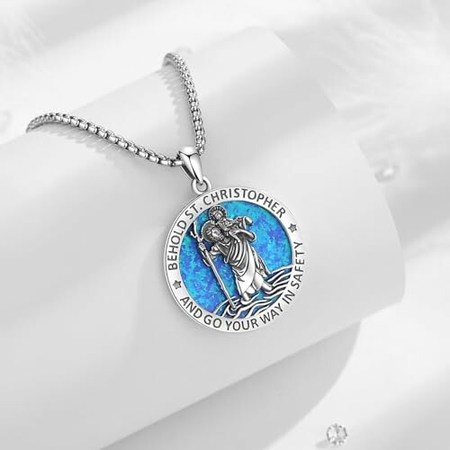 St. Christopher necklace with blue background on silver chain.