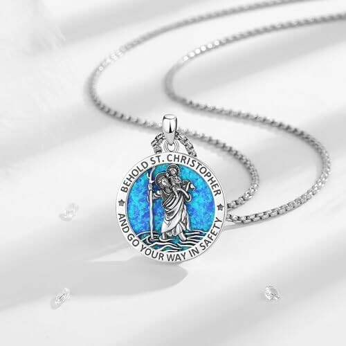 St. Christopher pendant necklace with blue background.