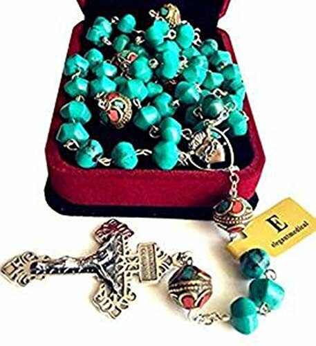 Turquoise rosary beads with ornate cross and jewelry box.