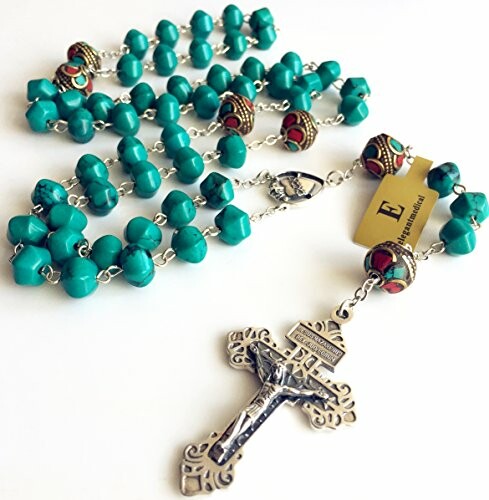 Turquoise rosary beads with ornate cross and decorative beads.