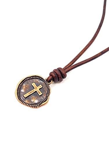 Vintage cross pendant on a leather necklace.