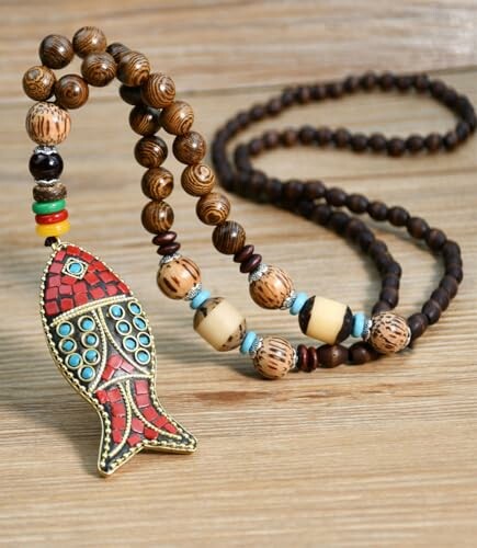 Wooden beaded necklace with colorful fish pendant on wooden surface.