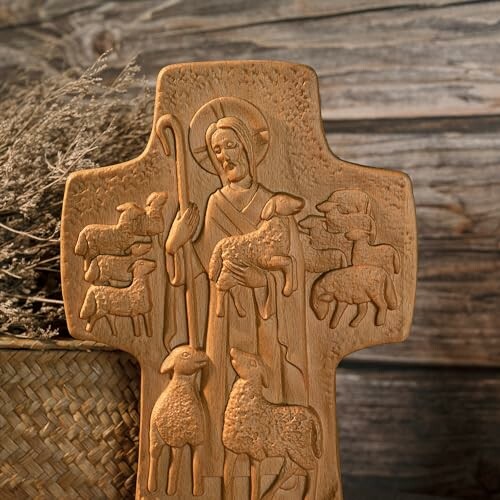 Wooden cross with carved shepherd and sheep design.