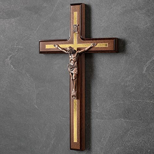 Wooden crucifix with gold accents on a wall.