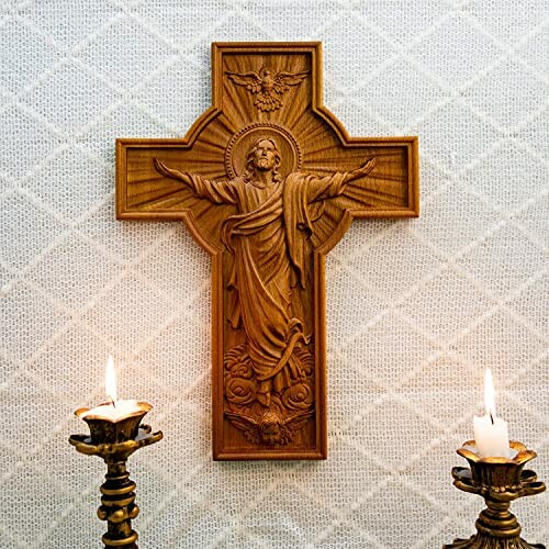 A wooden crucifix with Jesus and two lit candles
