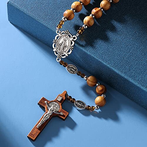 Wooden rosary beads with a crucifix and religious medallions.